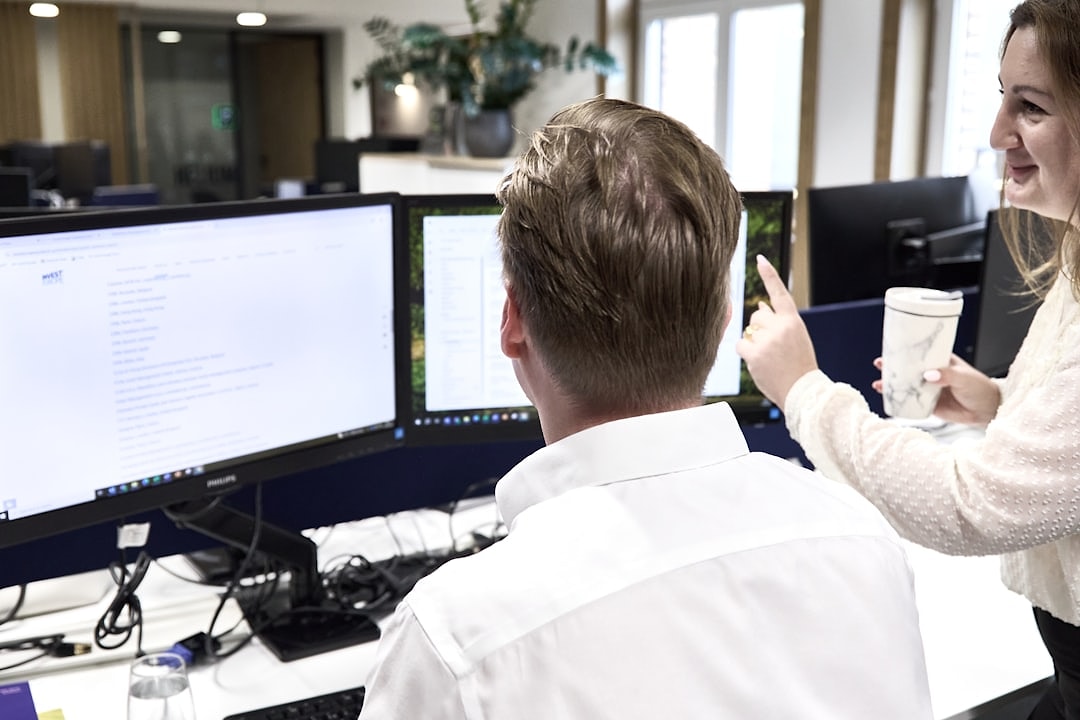 Professional analyzing financial data on a computer in a Vienna office setting.